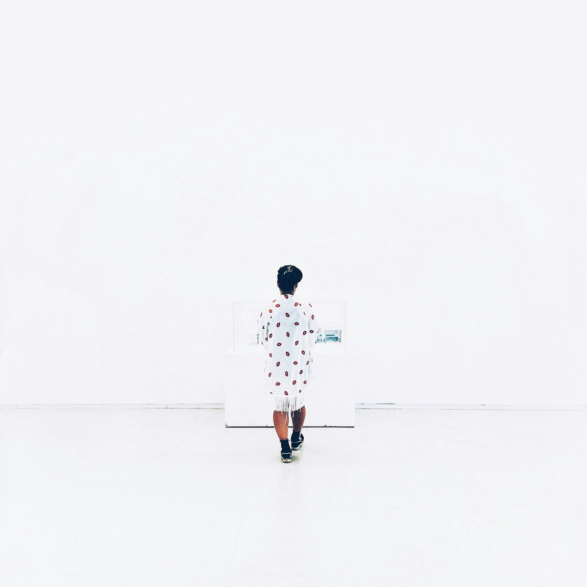 woman in white and red polka dot mini dress