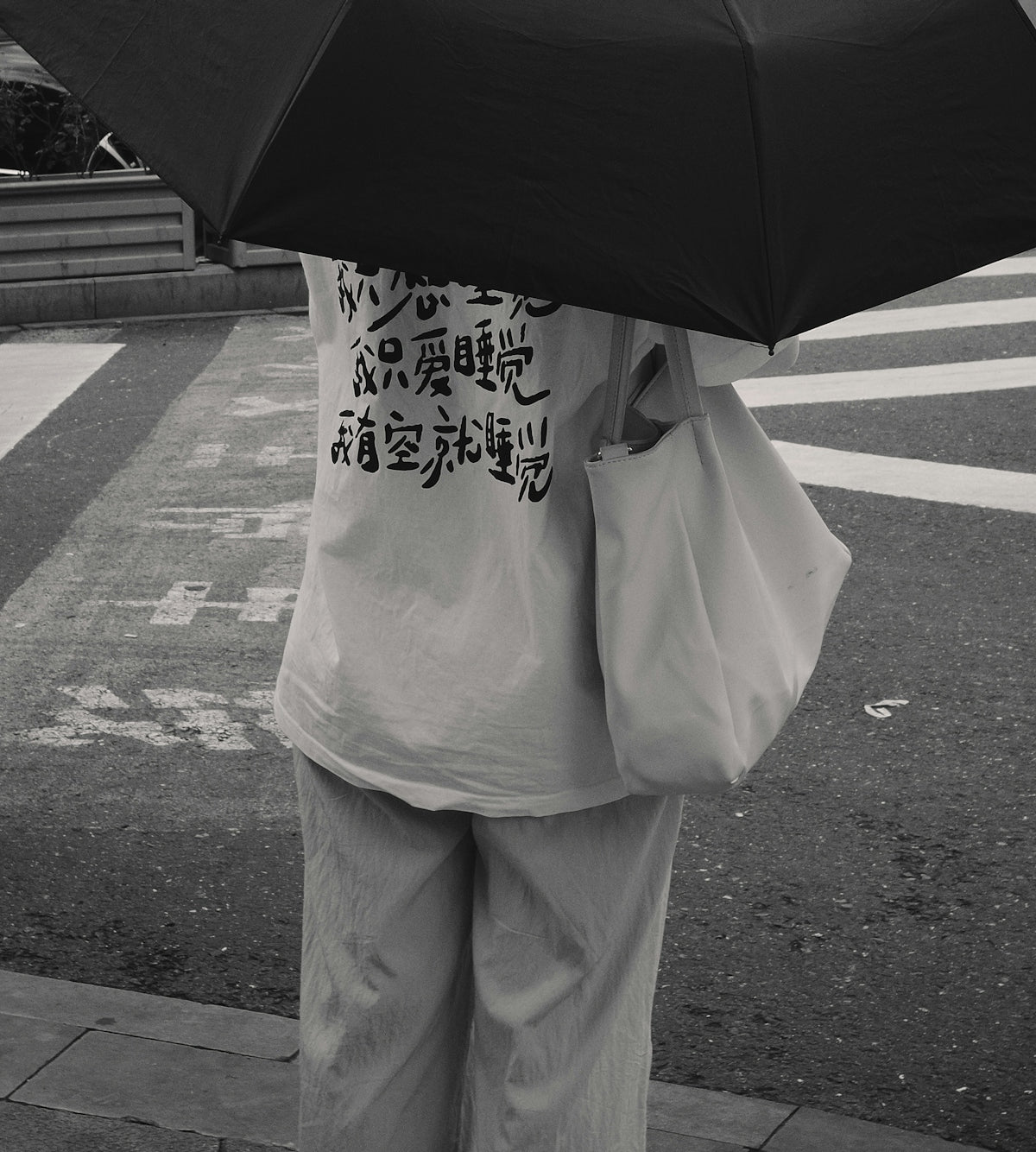 a person holding an umbrella on a city street