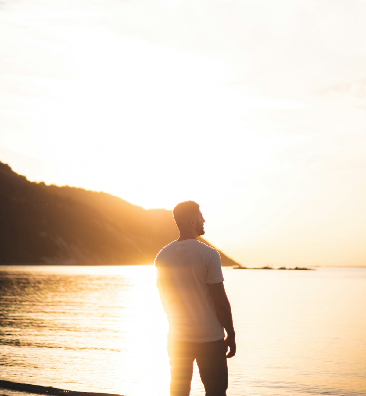 A man gazes at a beautiful sunset.