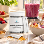 Bee Bread Powder 2,500mg with Royal Jelly & Propolis on a sunny kitchen counter beside a blender of berry smoothie
