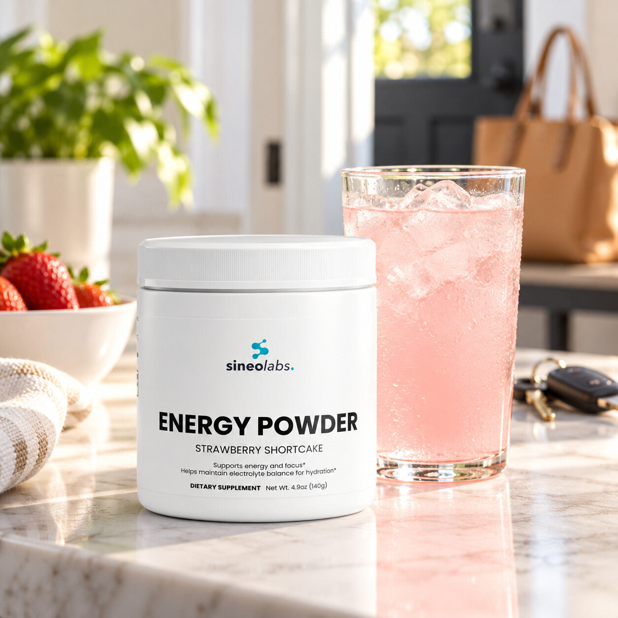Energy Powder, 200mg Caffeine, Strawberry Shortcake on a bright kitchen counter in morning light beside a tall glass of pale pink drink with ice