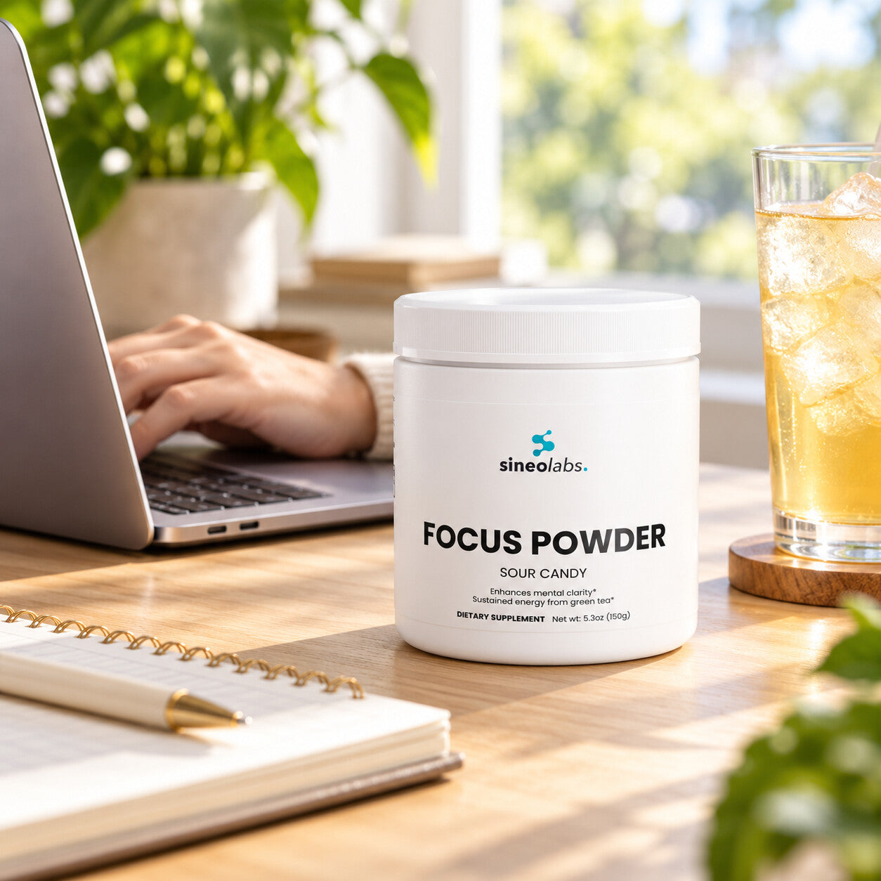 Focus Powder, 300mg Alpha GPC, Sour Candy on a tidy desk in bright late-morning light beside an open laptop and a tall glass of iced drink