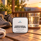 Cordyceps & Shilajit Oral Strips, Chocolate on a wooden porch table in warm evening light beside a glass of water and a pair of walking shoes