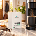 Molten Caramel Dark Roast Single-Serve Coffee Pods on a kitchen counter beside a single-serve coffee maker filling a dark mug