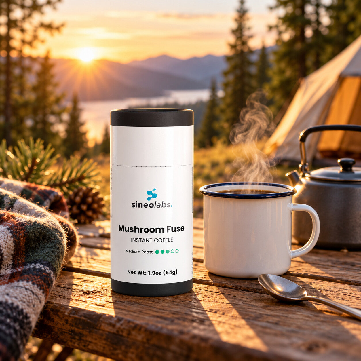 Mushroom Fuse Instant Coffee with Lion's Mane on a wooden camp table at sunrise beside a steaming enamel mug