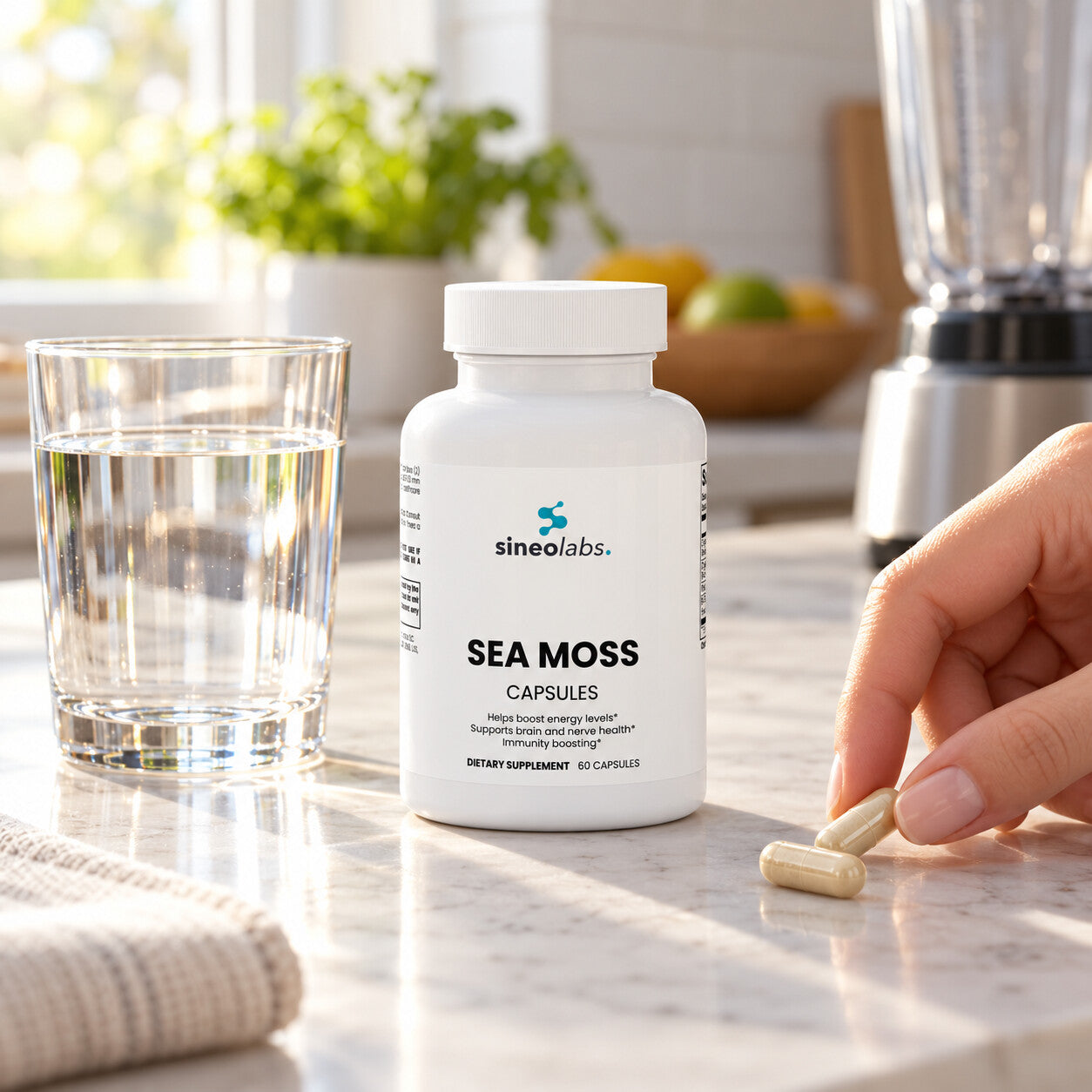Sea Moss Capsules with Bladderwrack on a clean kitchen counter in soft morning light beside a glass of water and an empty blender pushed aside