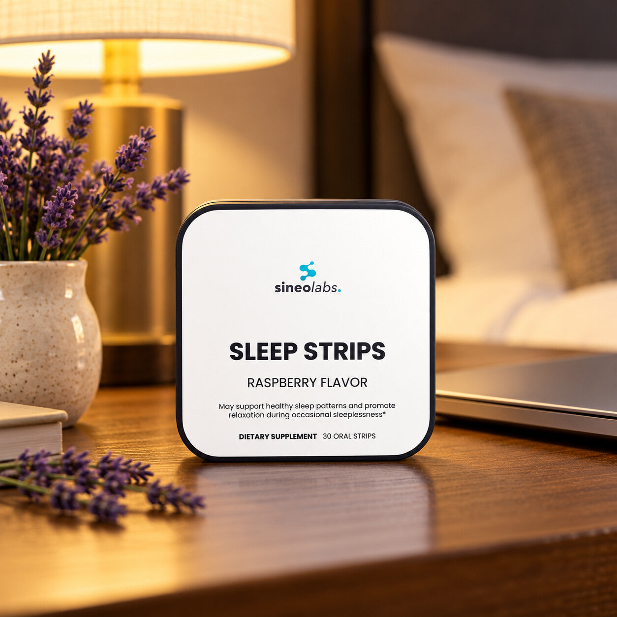 Sleep Strips with Valerian Root, Raspberry on a quiet hotel room desk in soft lamp light